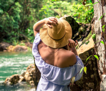girl in hat at the river