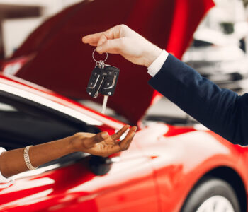 Stylish black woman in a car salon